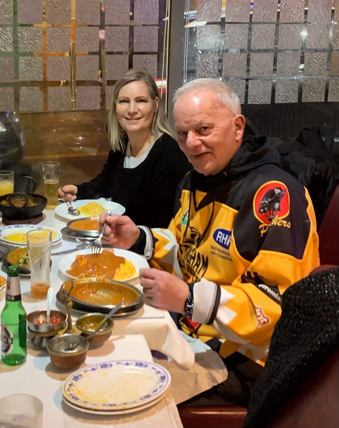 Two customers eating curry at The Balti House, one wearing a Nottingham Panthers ice hockey jersey
