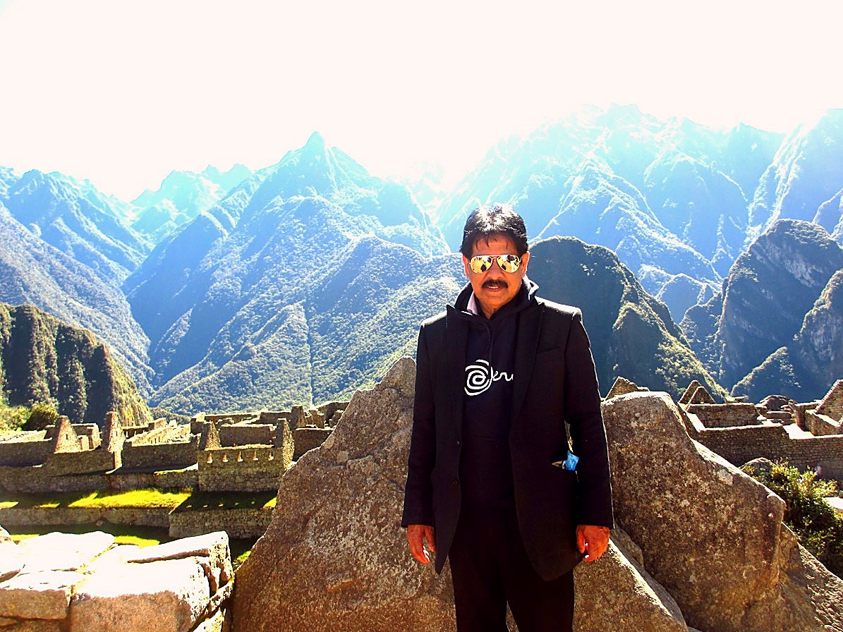 Sabbir Hossain standing at Machu Picchu, Peru, September 2013, with the mountains behind him